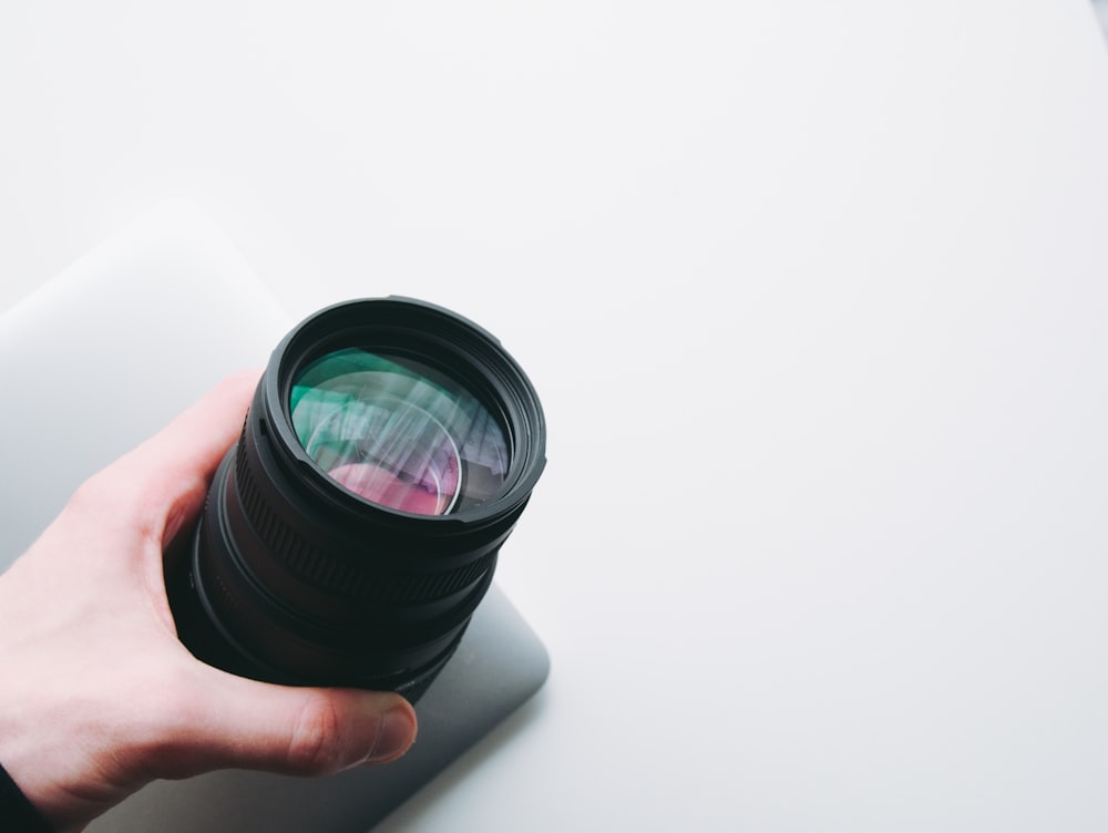 person holding telephoto lens