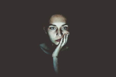 woman with head resting on hand bored zoom background