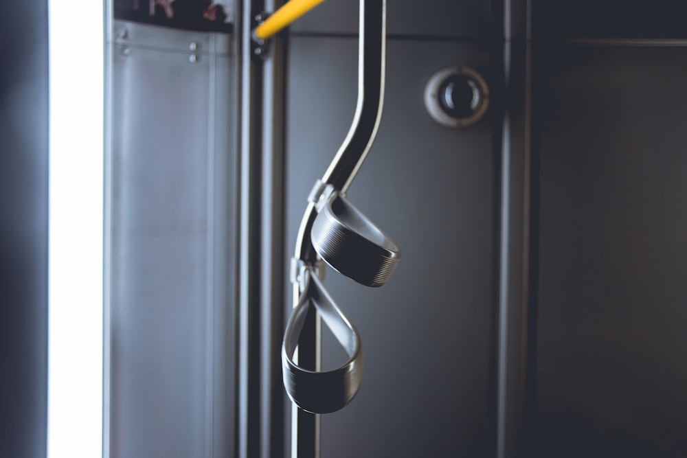 a pair of scissors hanging from a hook on a door