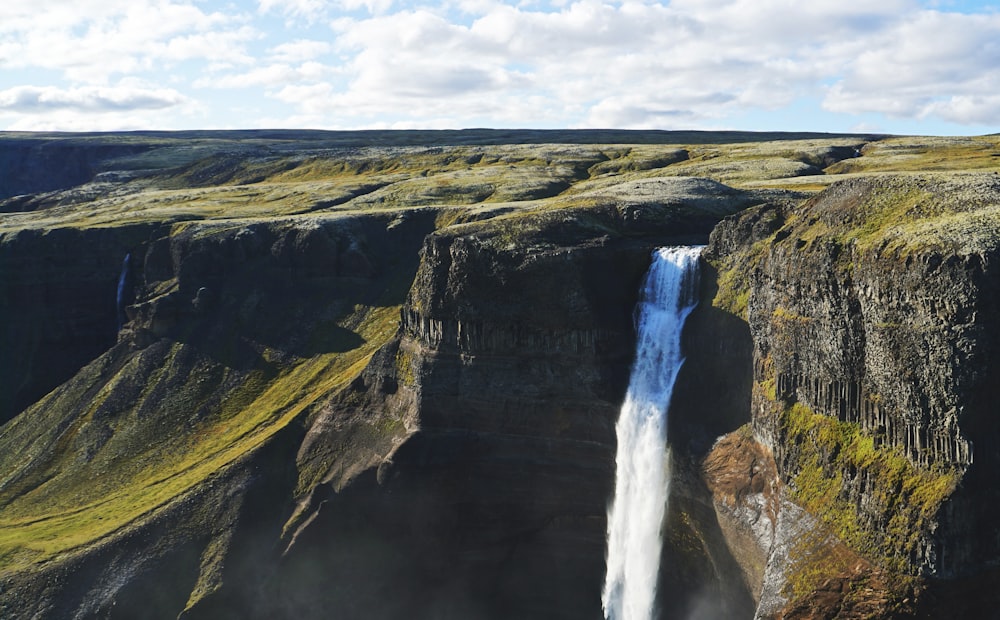 waterfalls surrounded with moutain range