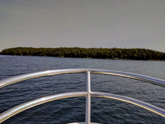 Panoramic view of the Borromean Islands from a maboat, framed by clear skies and calm waters.