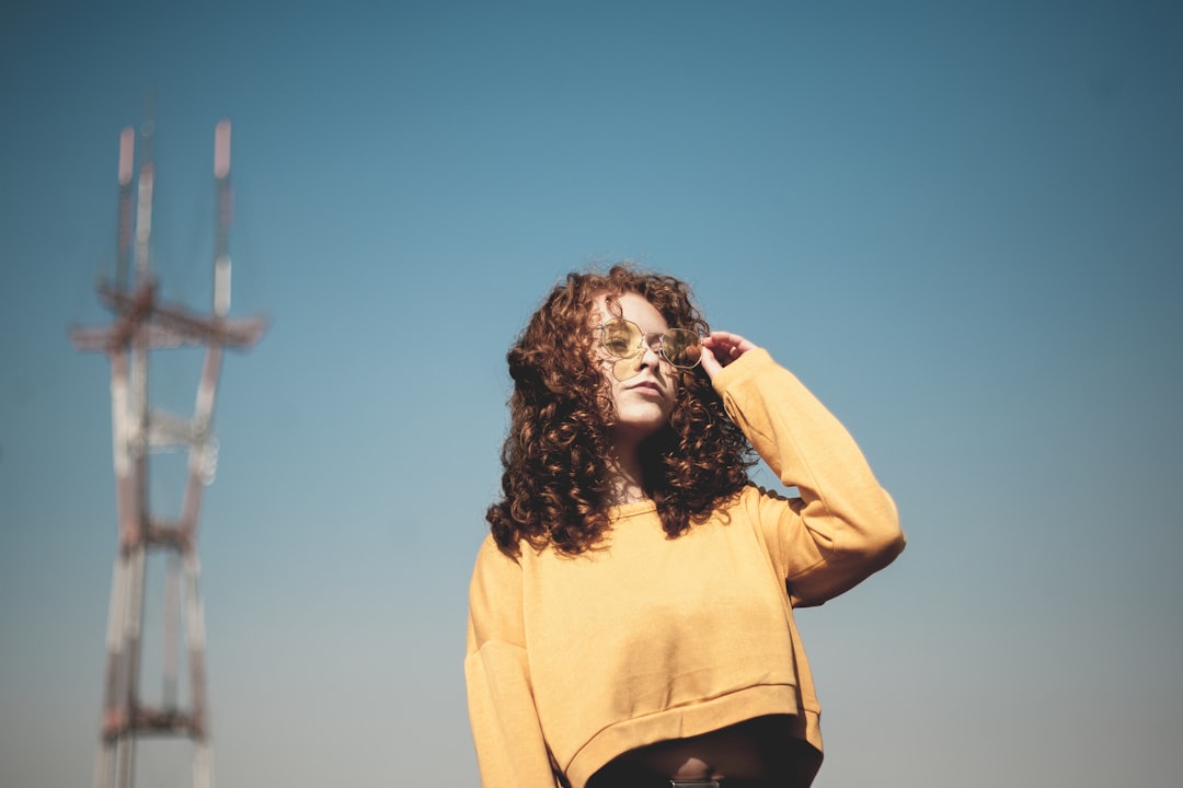 woman wearing sweater standing near tower