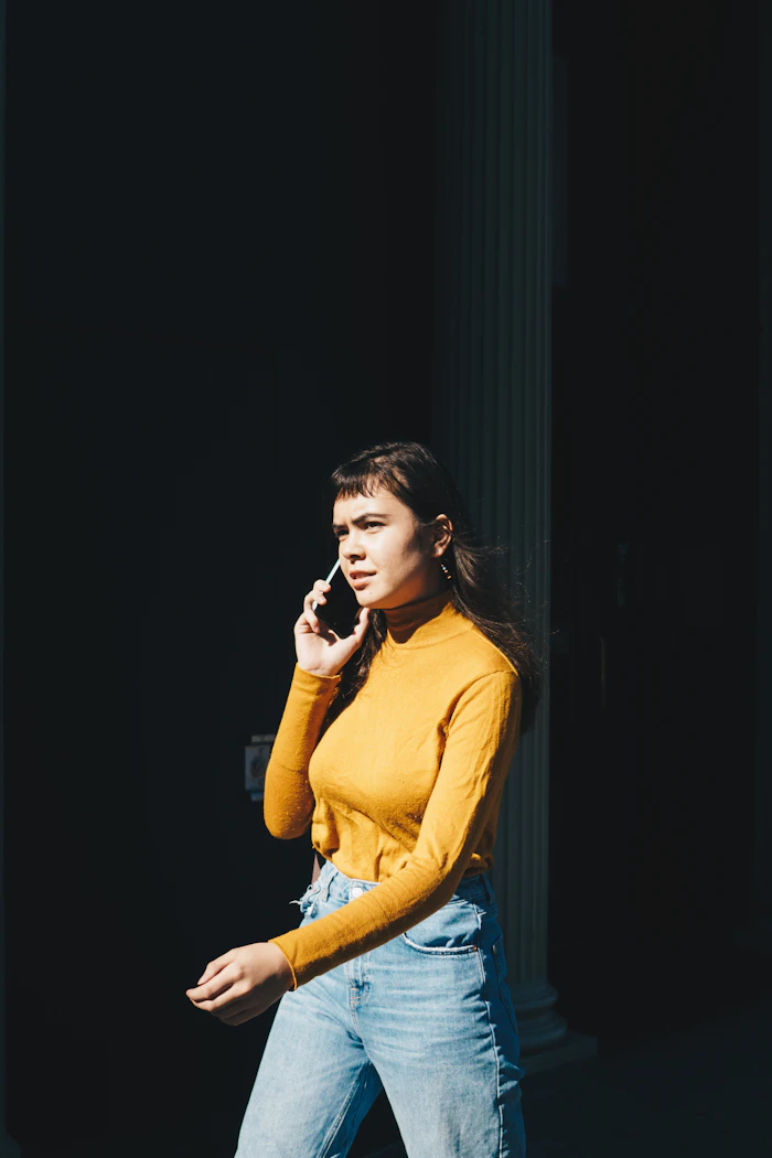A person talking on the phone outdoors