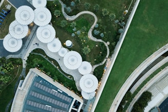 Aerial view of a modern urban park with green spaces and walking paths.