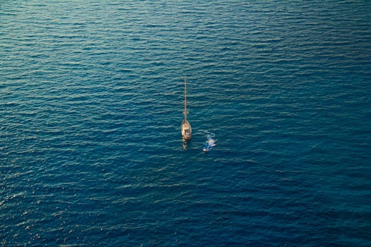 white boat in the sea during daytime in Zakinthos Greece