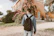 A young adult with a backpack, confidently walking towards a new job opportunity.