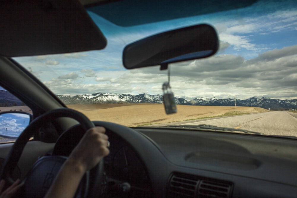 person driving car during daytime