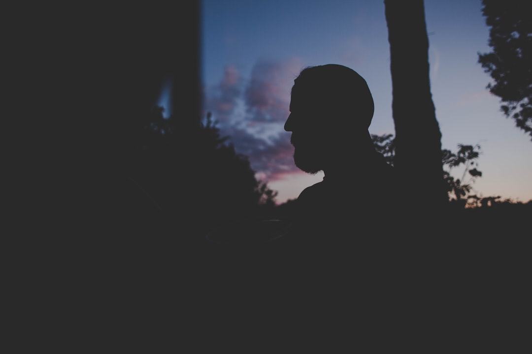 man standing near tree during night time