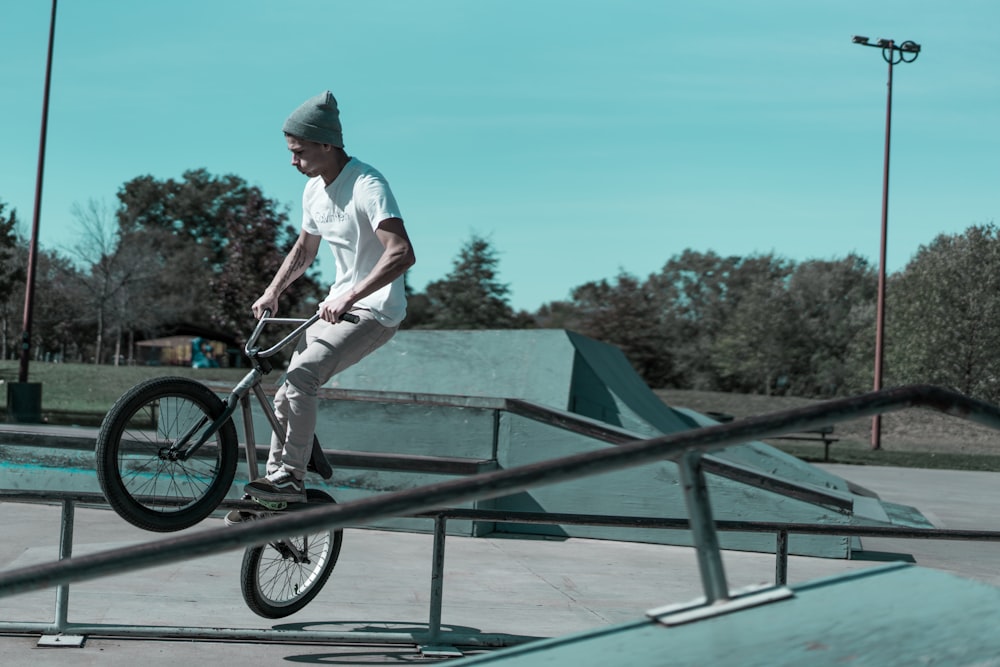 man using BMX bike jumping on trail