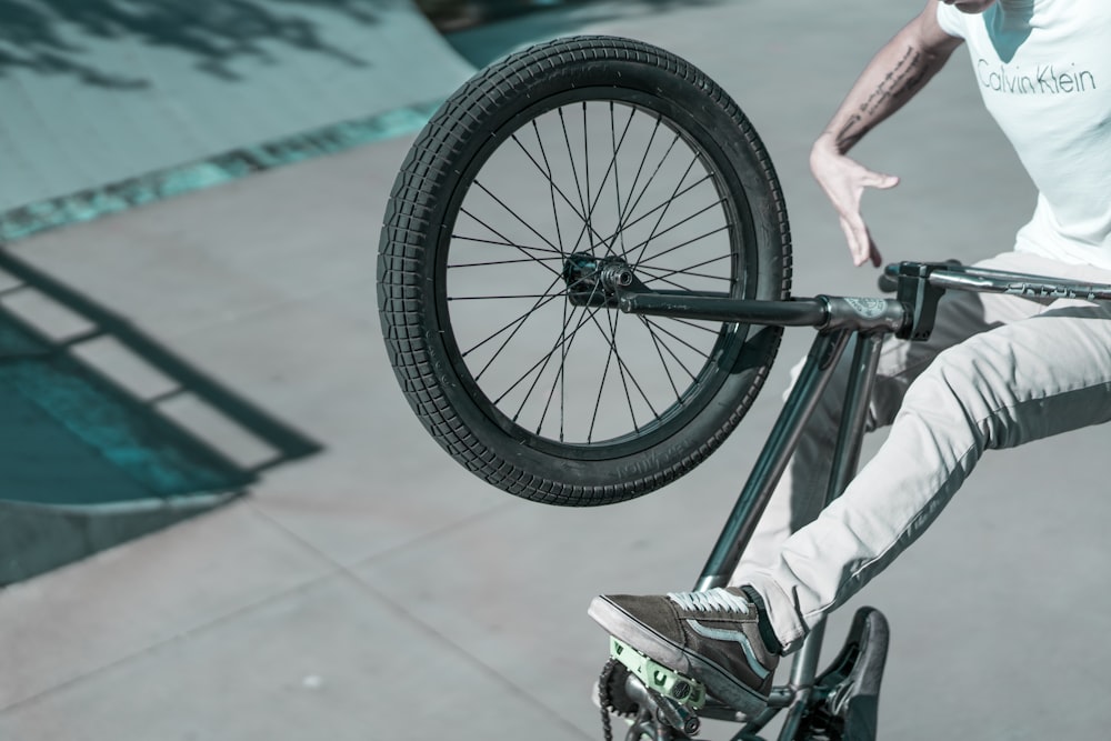 man doing BMX stunt at daytime