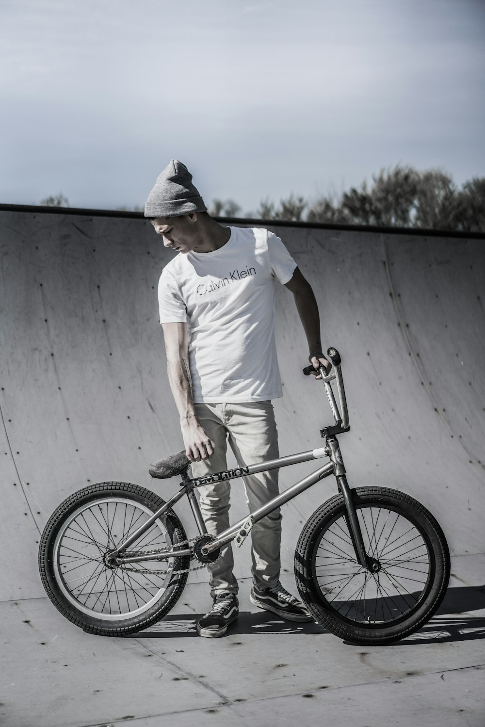 man holding BMX bike standing near bike track