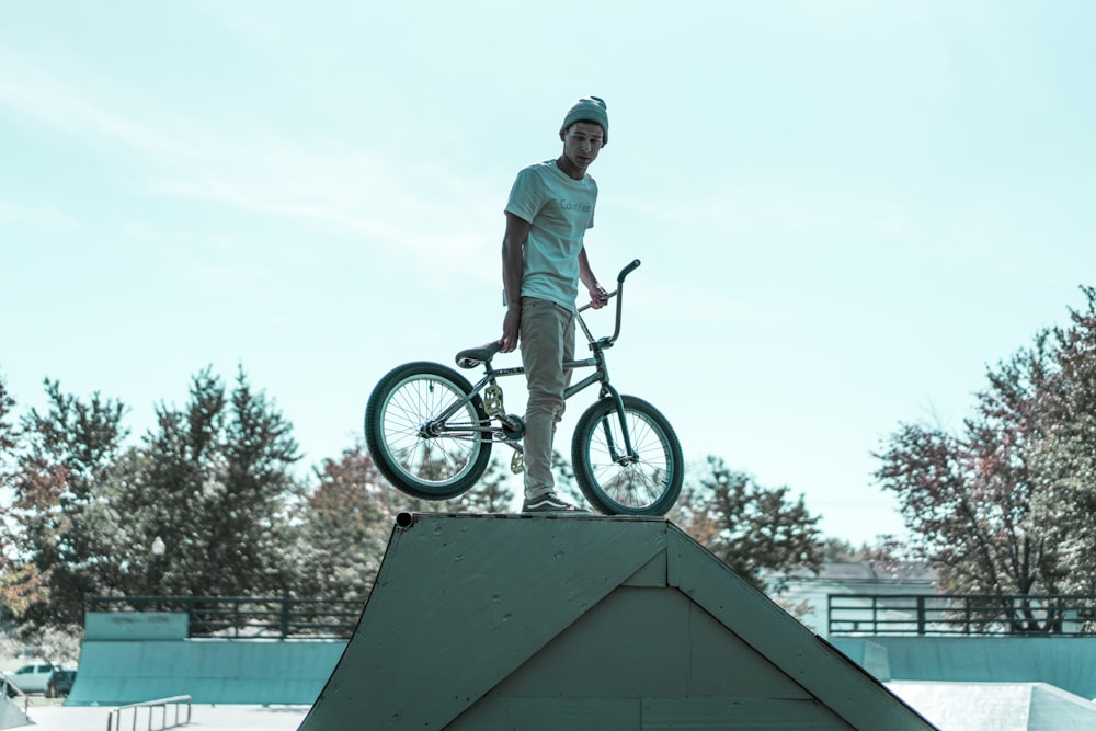 person holding BMX bike