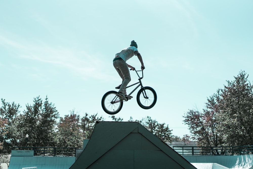 man on bicycle while on ramping grounds