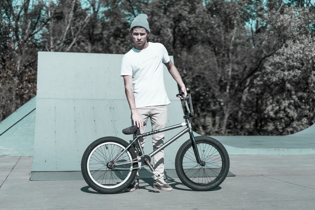 man holding BMX bike