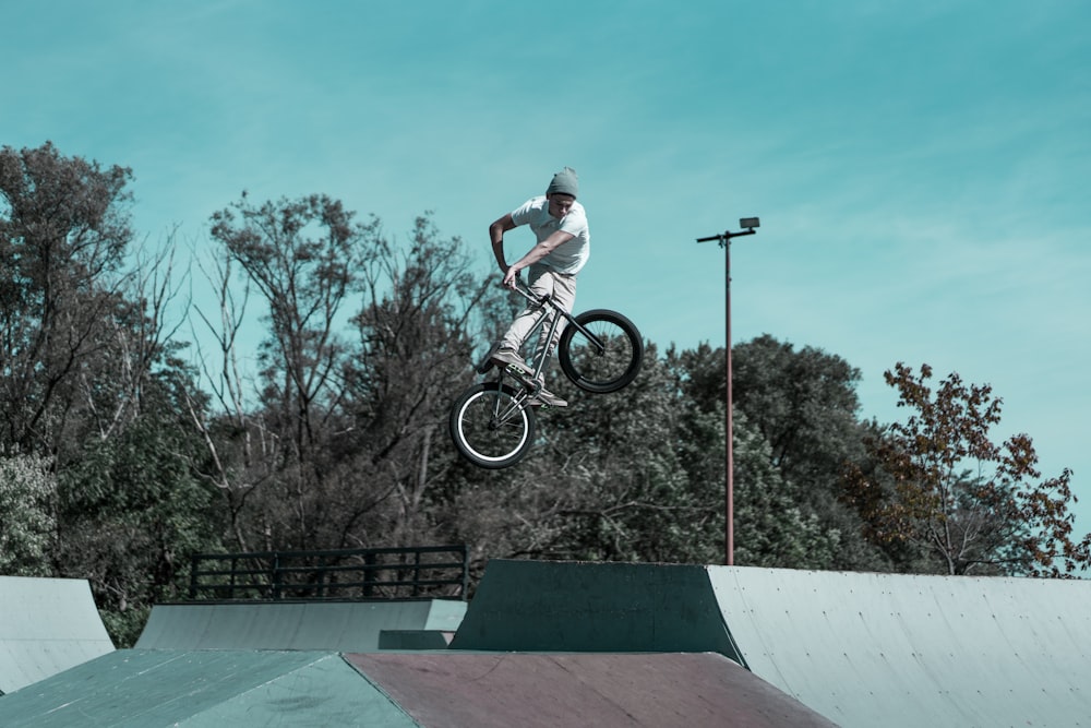 man riding bike performed trick above ramp