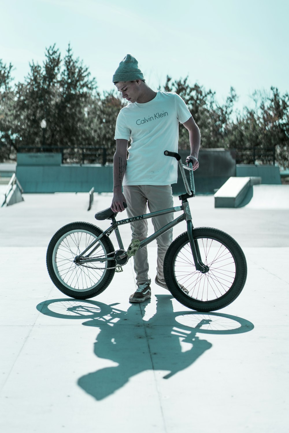 hombre de pie y sosteniendo una bicicleta BMX