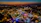 Colorful amusement park at dusk with glowing lights and happy visitors