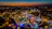 Colorful amusement park at dusk with glowing lights and happy visitors