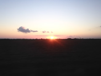A serene North Dakota prairie under a wide, open sky at sunset.