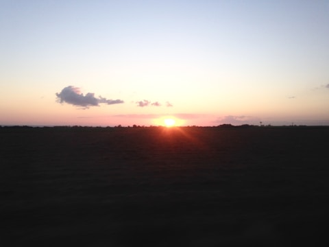 A serene North Dakota prairie under a wide, open sky at sunset.