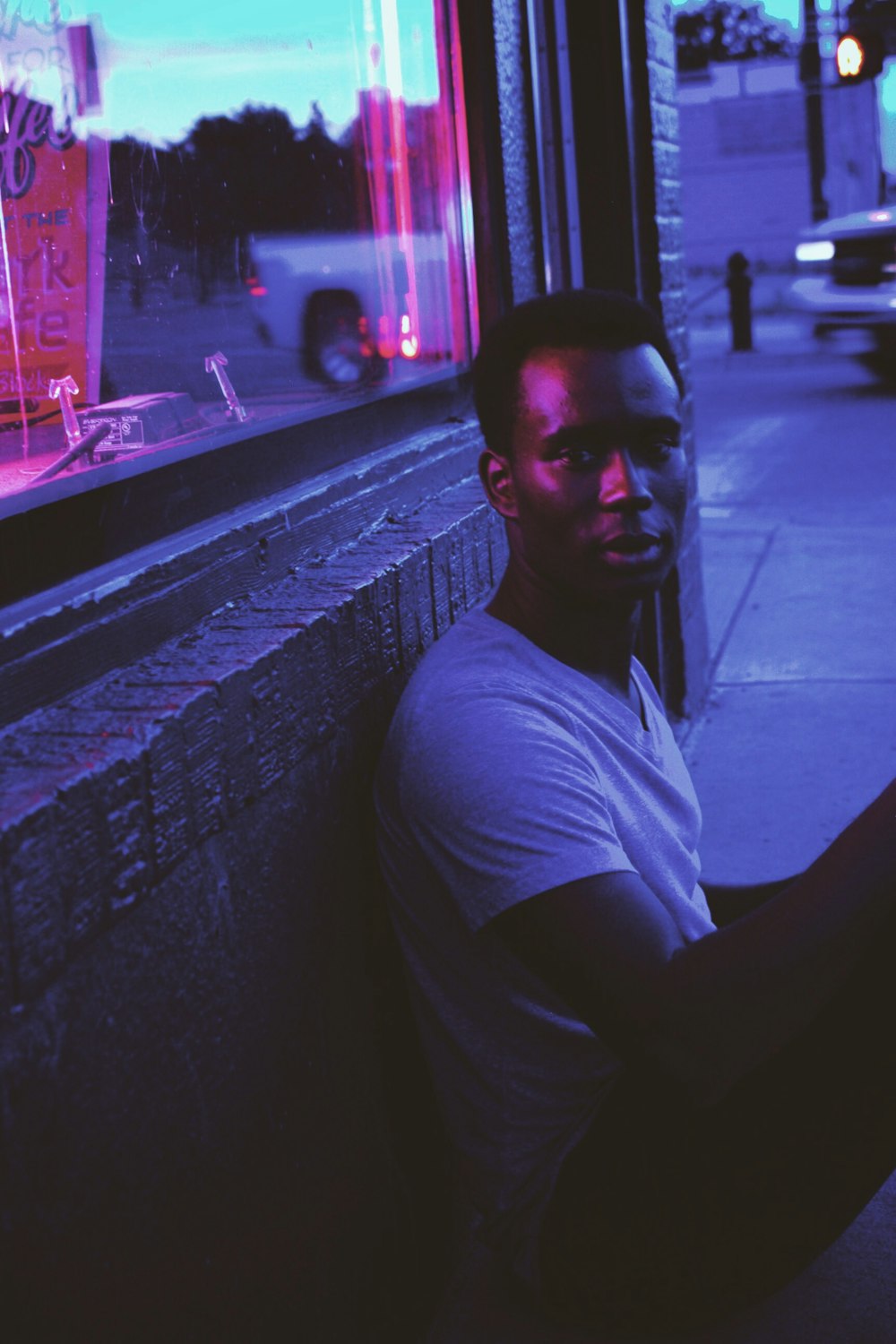 man sitting outside store