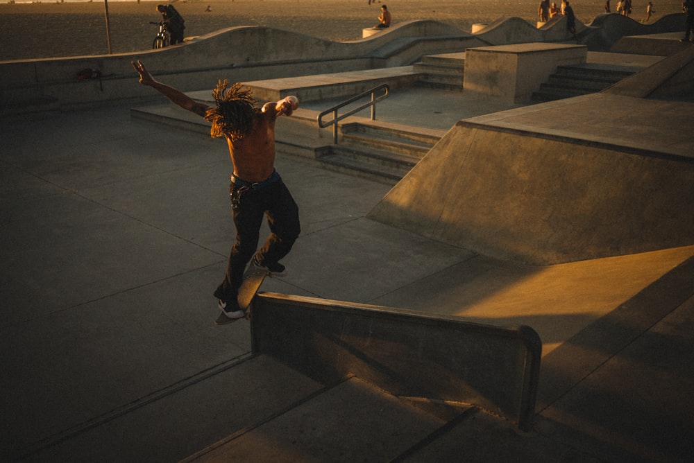 topless man doing skateboard tricks