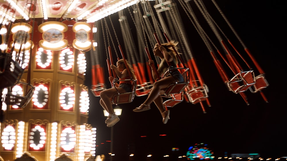 photo of woman riding on carousel