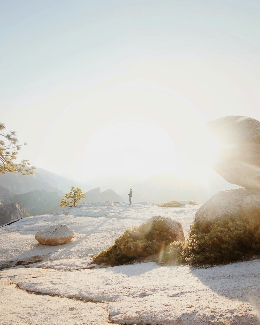 man standing on cliff at sunset