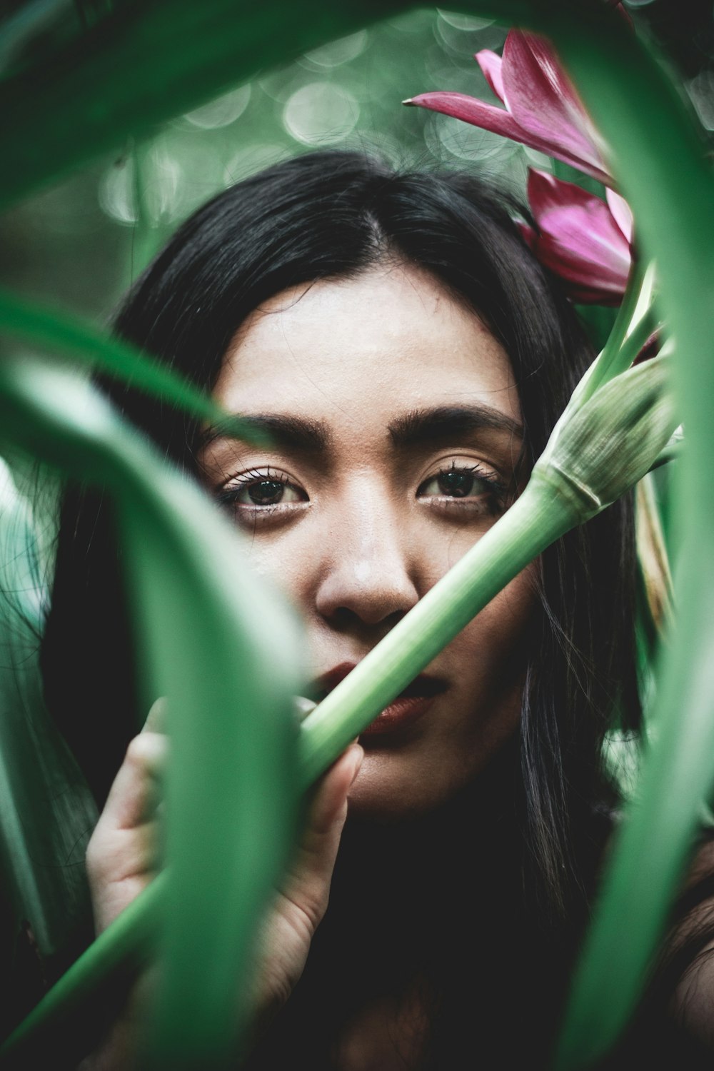 woman behind plants