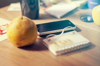 Close-up of a phone charging device integrated seamlessly into a convention table setup with branded schedules on screen.