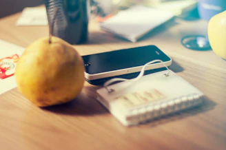 Close-up of a sleek premium charging cable plugged into a smartphone on a wooden desk.