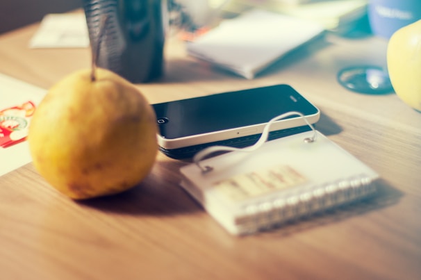 Close-up of eco-friendly phone accessories arranged on a wooden table with natural light.