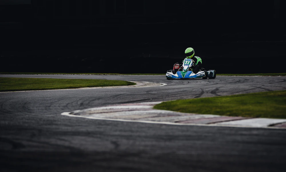 Karts lined up on the Two Rivers floodlit sprint circuit at dusk