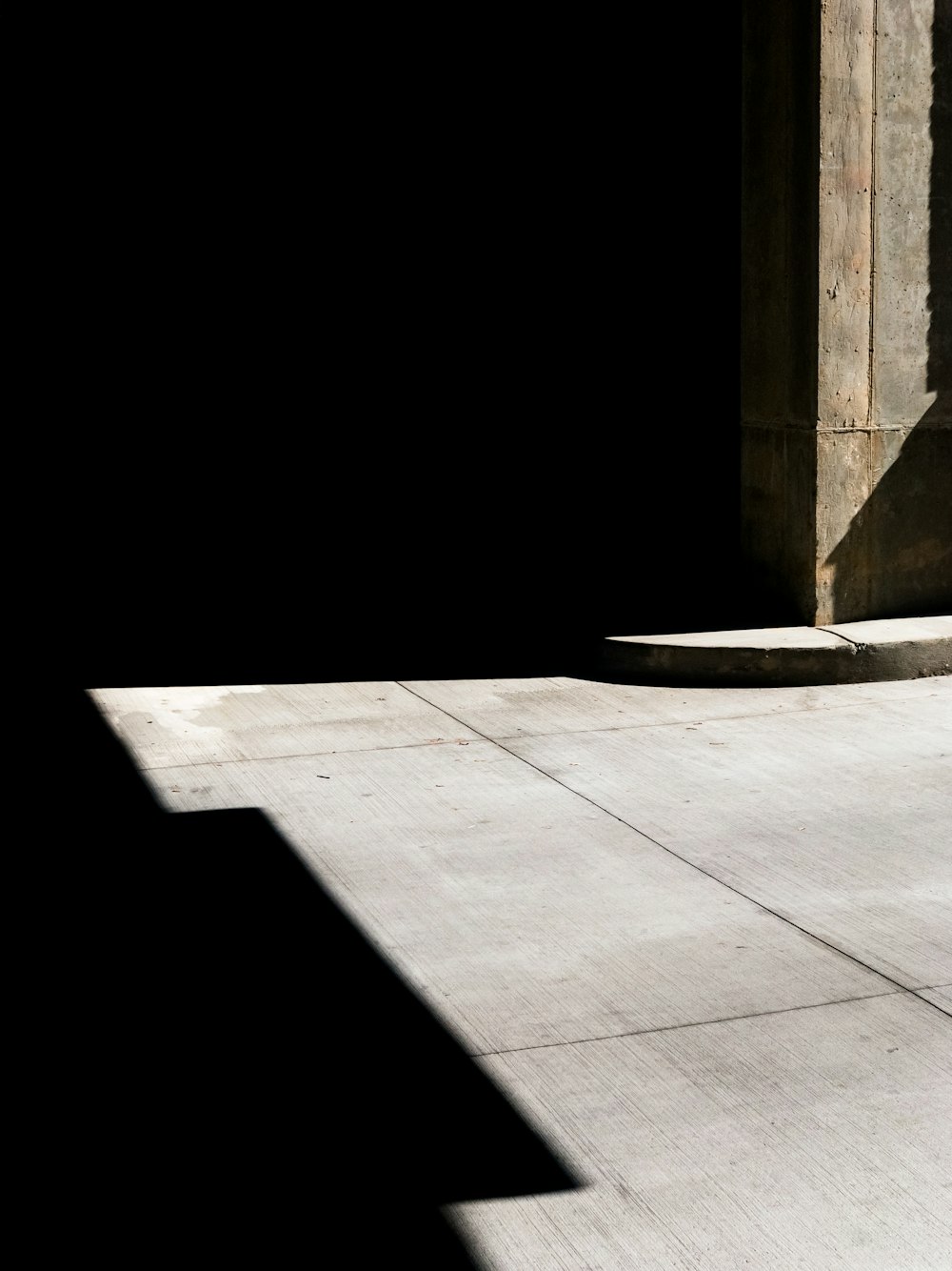 a man riding a skateboard down a sidewalk