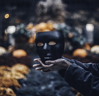 person holding black mask
