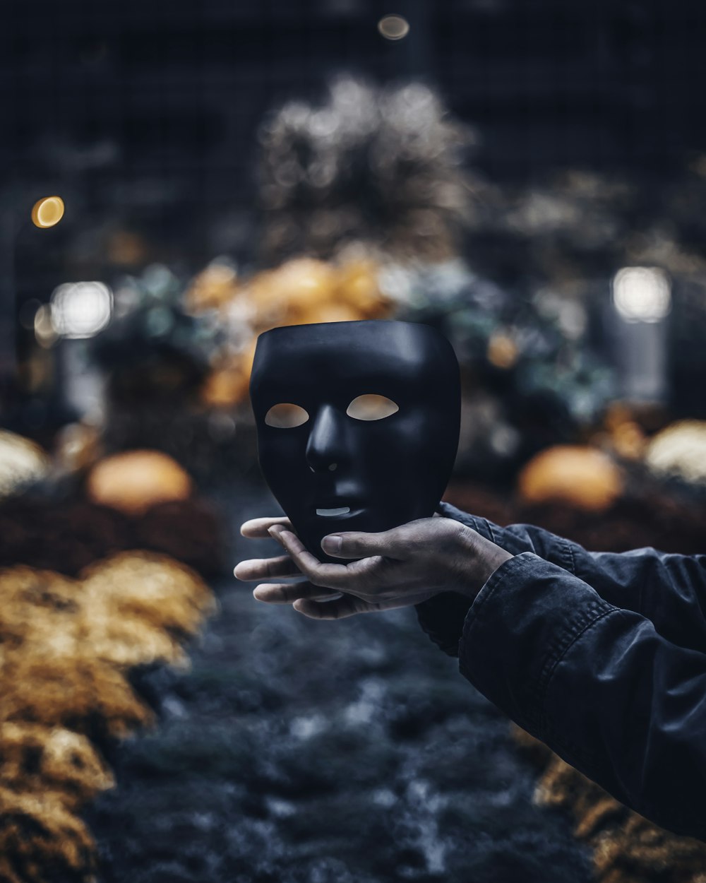 person holding black mask