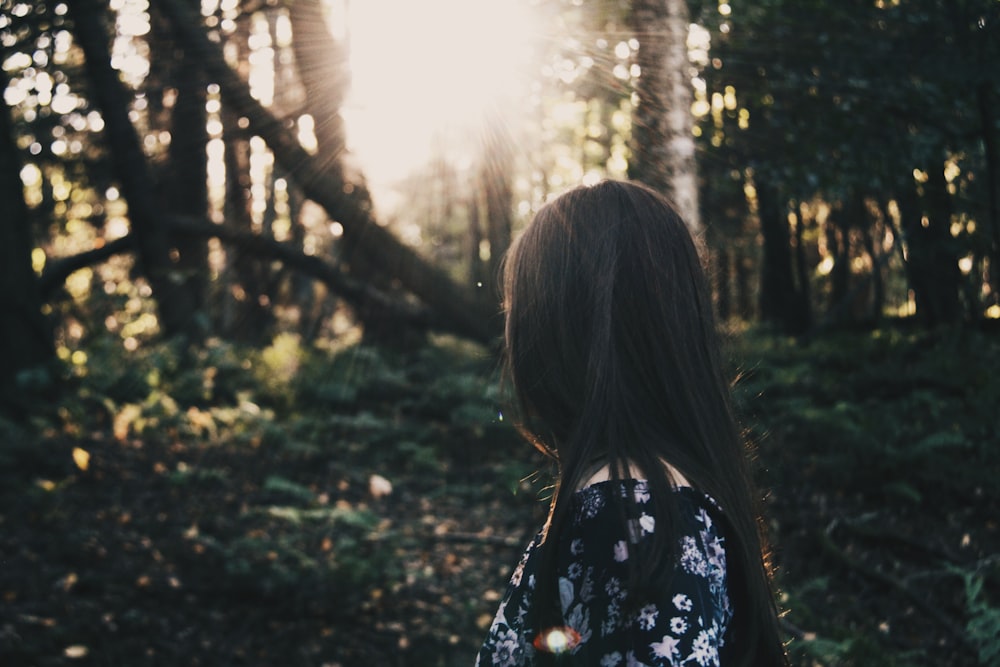 woman in black top surrounded trees