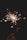 A bright sparkler is held against a dark background, emitting sparks in all directions. The sparks create a dynamic and shimmering effect, illuminating the surroundings with a warm glow.