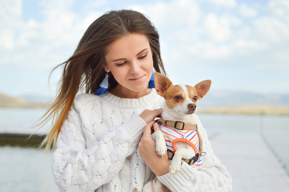 mujer cargando perro fotografía de cerca