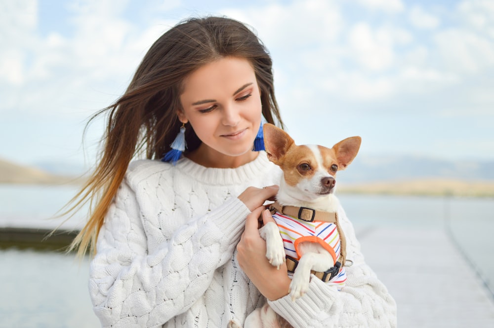 woman carrying dog close up photography