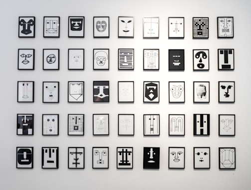A collection of framed minimal logo prints arranged on a wall.