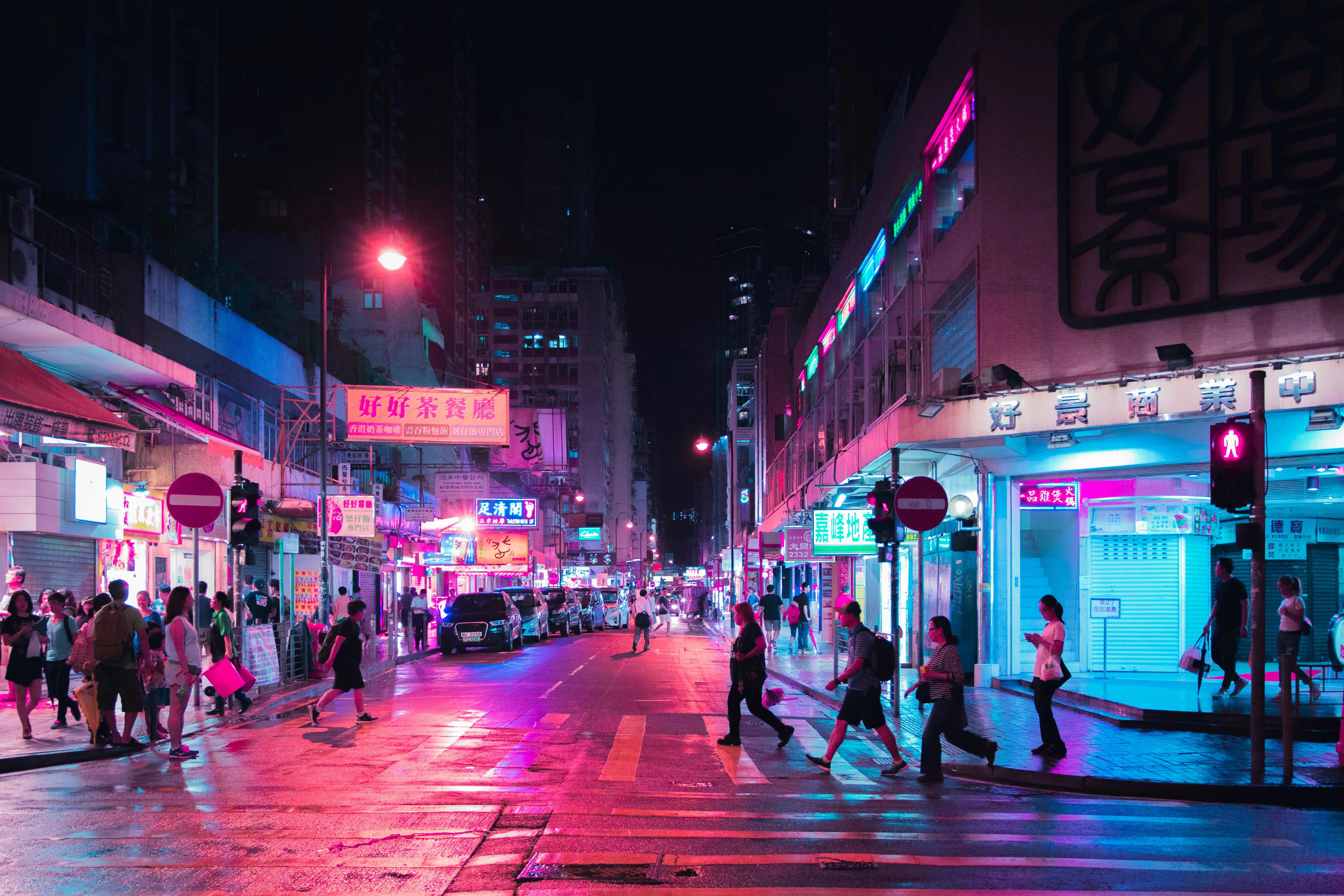 Colorful neon lights in pink and electric blue casting vibrant reflections, futuristic nightlife atmosphere