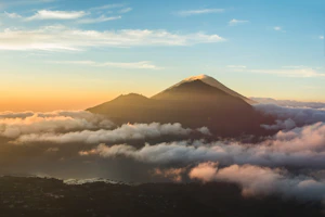 mountain over bed of clouds