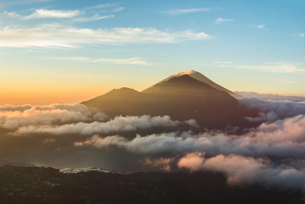 mountain over bed of clouds