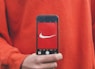 person holding iPhone taking picture on Nike label