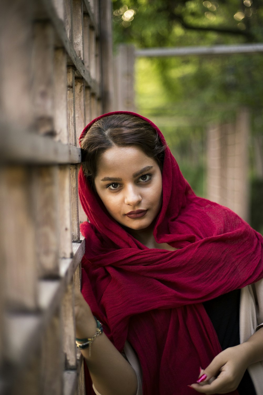 woman leaning on white fence