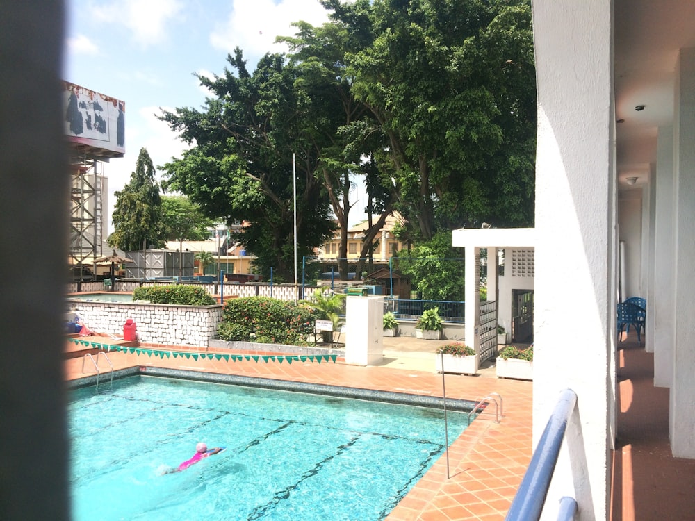 person swimming on pool