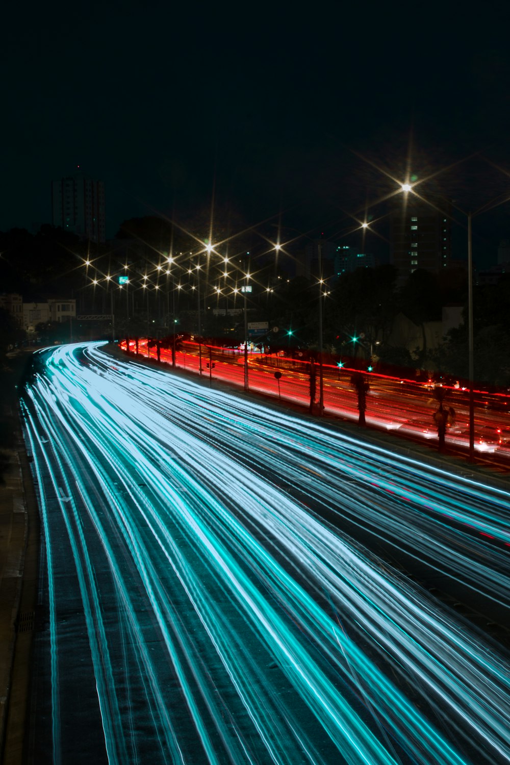 a long exposure photo of a highway at night