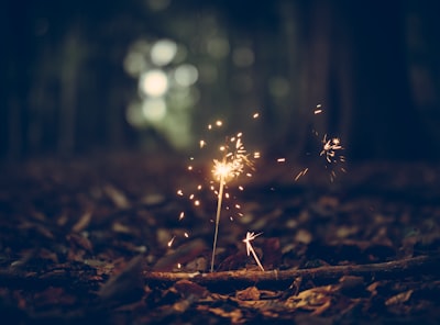 selective focus photography of sparklers sparkle zoom background