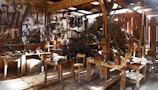 Family-owned workshop interior with vintage leather tools neatly arranged, bathed in warm sunlight.